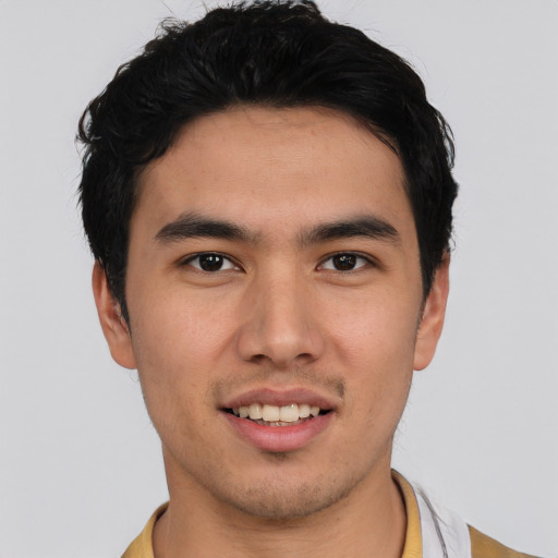 Joyful asian young-adult male with short  black hair and brown eyes