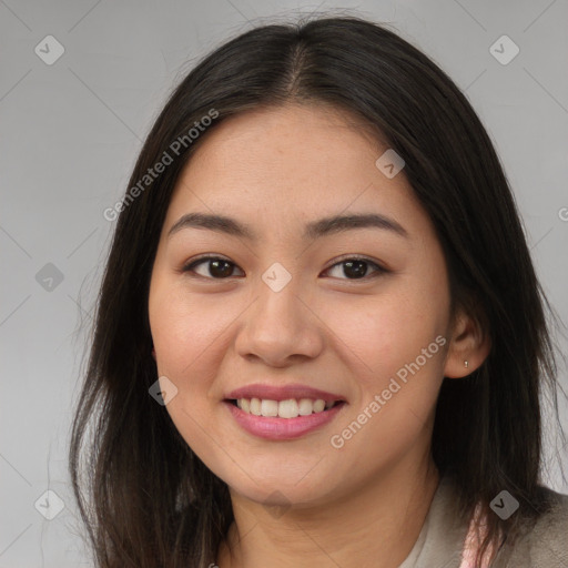 Joyful asian young-adult female with long  brown hair and brown eyes