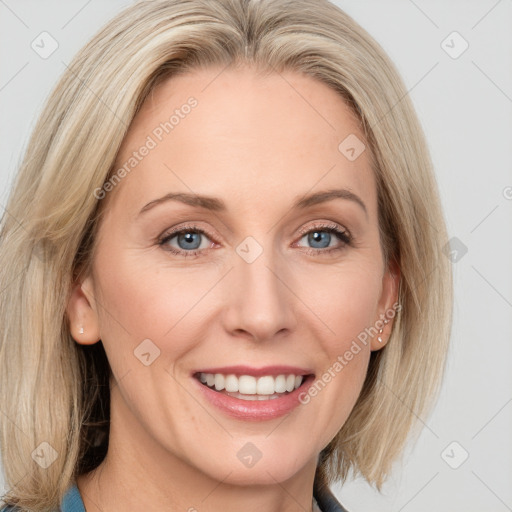 Joyful white adult female with long  brown hair and blue eyes