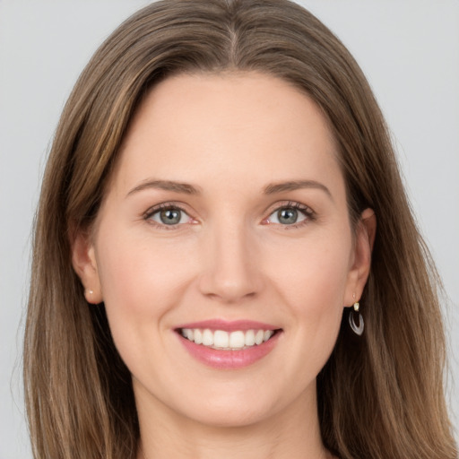 Joyful white young-adult female with long  brown hair and grey eyes