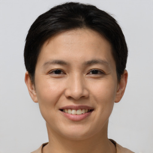 Joyful asian young-adult female with short  brown hair and brown eyes