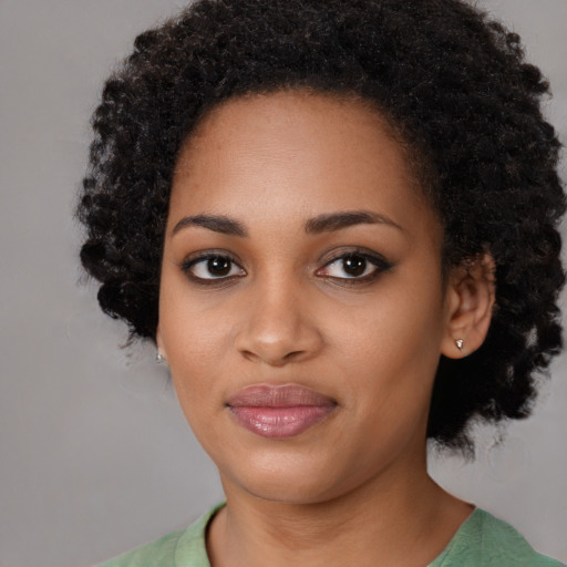 Joyful black young-adult female with medium  black hair and brown eyes