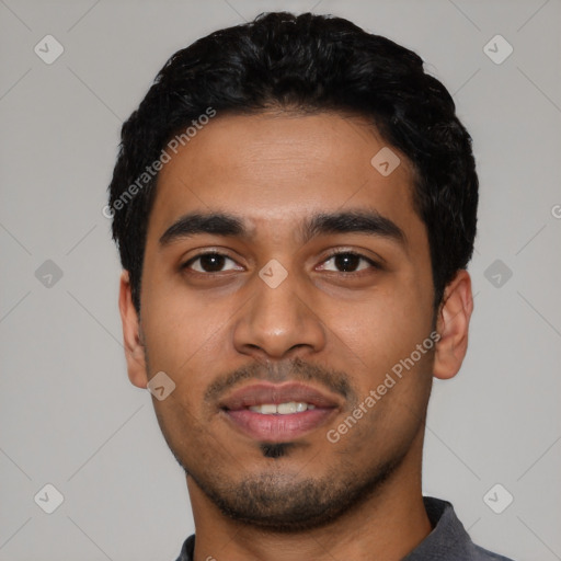 Joyful latino young-adult male with short  black hair and brown eyes