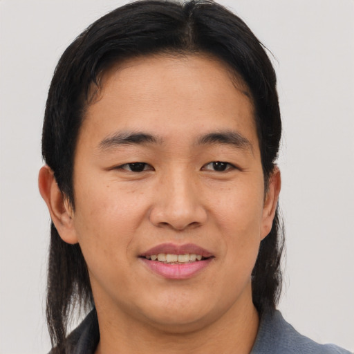 Joyful asian young-adult male with medium  brown hair and brown eyes