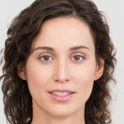 Joyful white young-adult female with medium  brown hair and green eyes