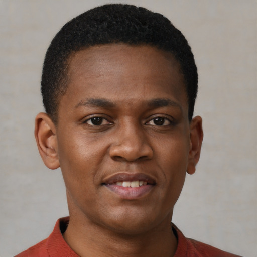 Joyful black young-adult male with short  brown hair and brown eyes