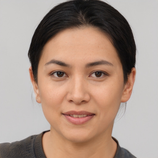 Joyful asian young-adult female with short  brown hair and brown eyes