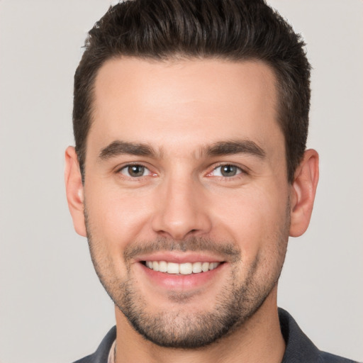 Joyful white young-adult male with short  brown hair and brown eyes