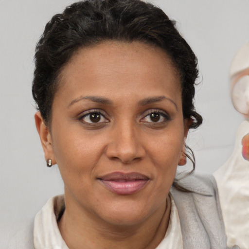 Joyful latino adult female with short  brown hair and brown eyes