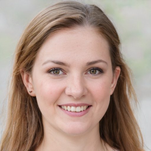 Joyful white young-adult female with long  brown hair and blue eyes