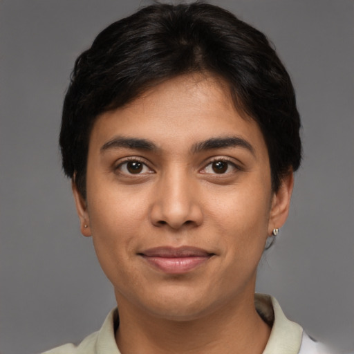 Joyful latino young-adult female with short  brown hair and brown eyes