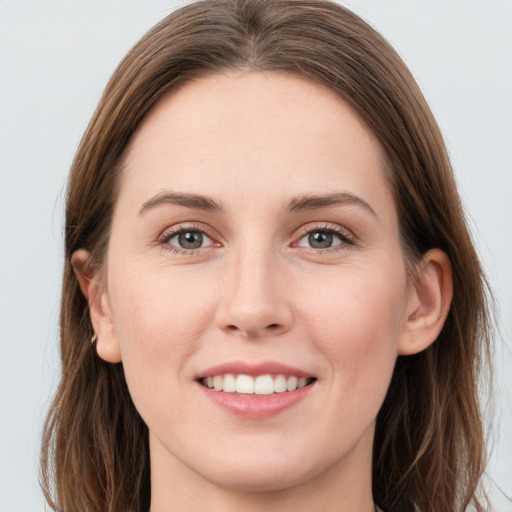 Joyful white young-adult female with long  brown hair and blue eyes