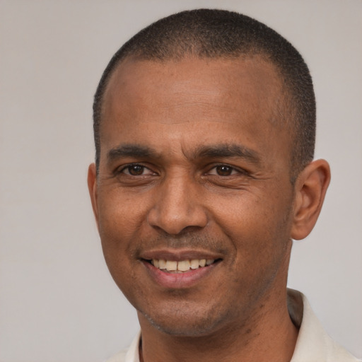 Joyful latino adult male with short  brown hair and brown eyes