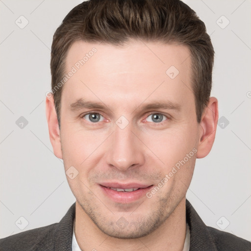 Joyful white young-adult male with short  brown hair and grey eyes