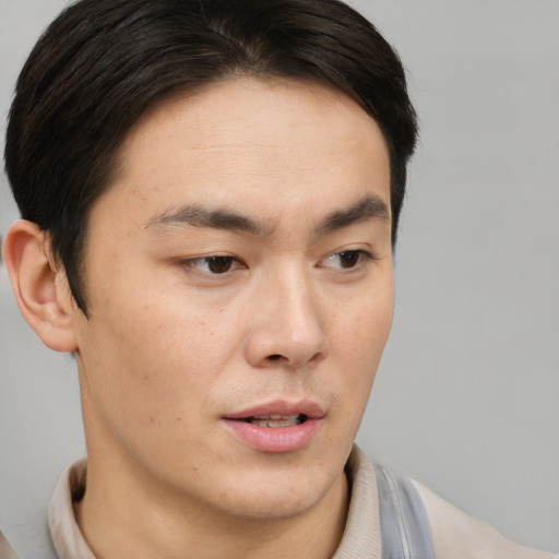 Neutral asian young-adult male with short  brown hair and brown eyes