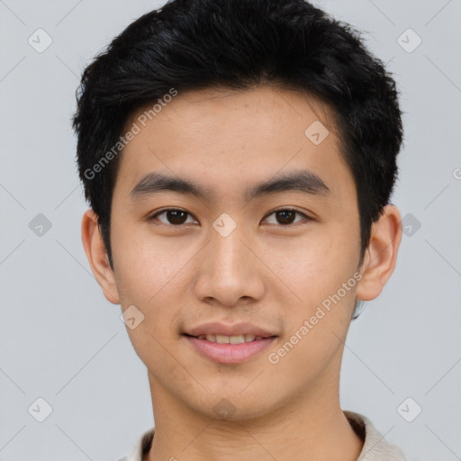 Joyful asian young-adult male with short  black hair and brown eyes