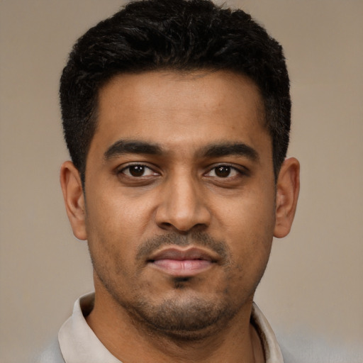 Joyful black young-adult male with short  black hair and brown eyes