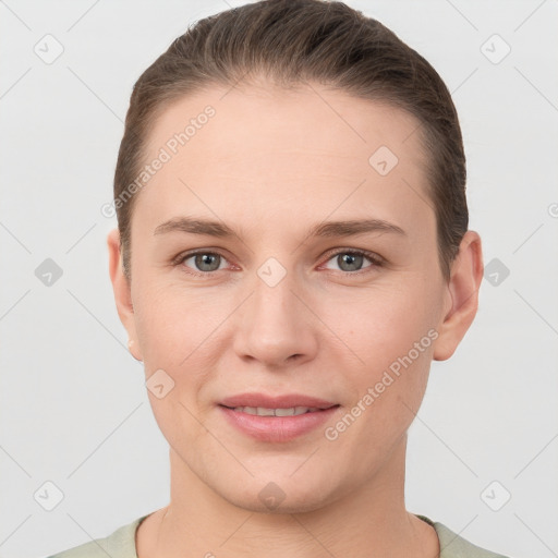 Joyful white young-adult female with short  brown hair and grey eyes