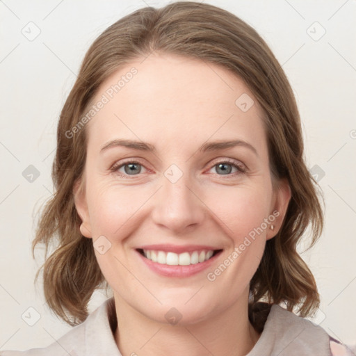 Joyful white young-adult female with medium  brown hair and green eyes