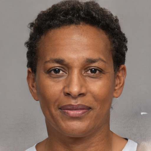 Joyful black adult female with short  brown hair and brown eyes