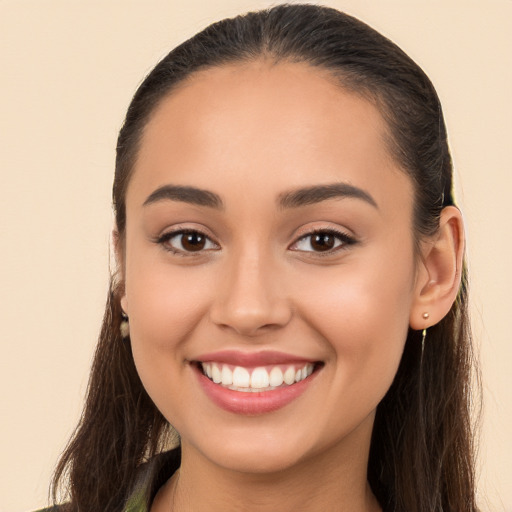 Joyful white young-adult female with long  brown hair and brown eyes