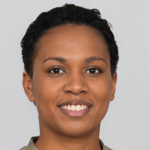Joyful black young-adult female with short  brown hair and brown eyes
