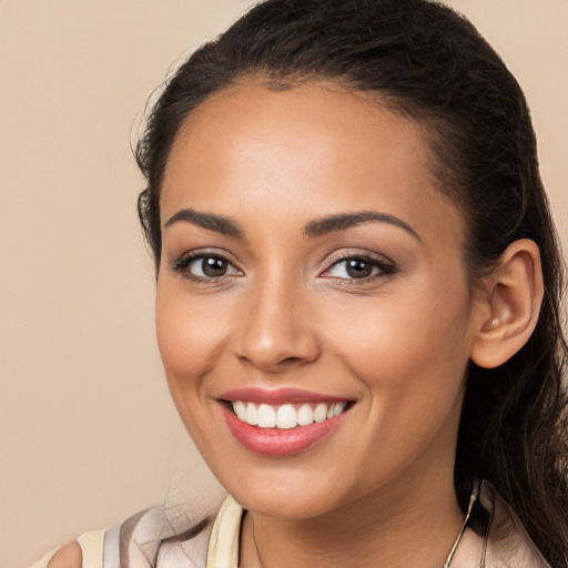 Joyful white young-adult female with long  brown hair and brown eyes