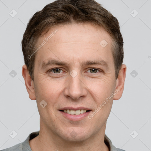 Joyful white adult male with short  brown hair and grey eyes