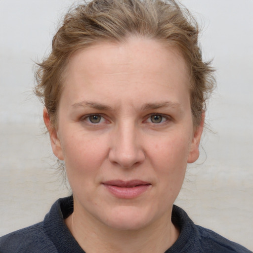 Joyful white young-adult female with medium  brown hair and blue eyes