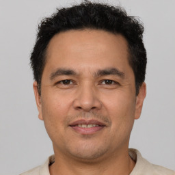 Joyful white adult male with short  brown hair and brown eyes