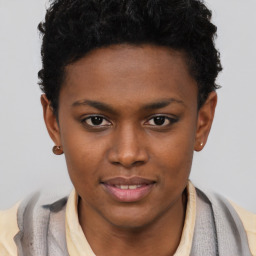 Joyful black young-adult female with short  brown hair and brown eyes