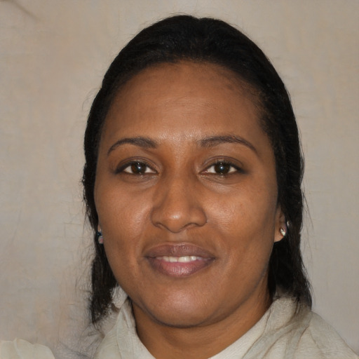 Joyful black adult female with medium  black hair and brown eyes