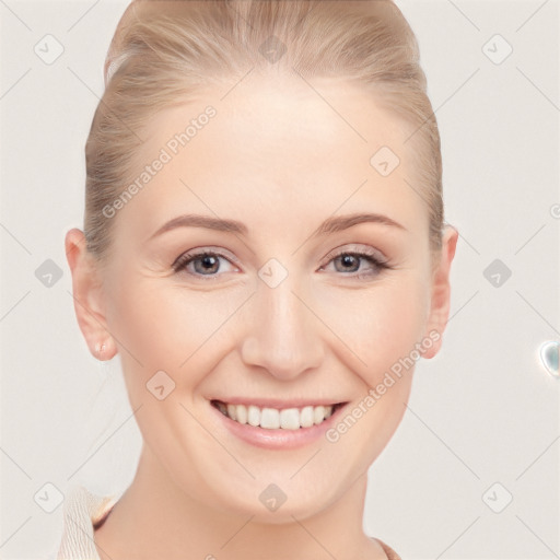 Joyful white young-adult female with short  brown hair and blue eyes