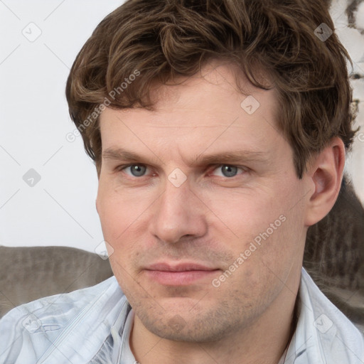 Joyful white adult male with short  brown hair and grey eyes