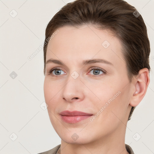 Joyful white young-adult female with short  brown hair and grey eyes