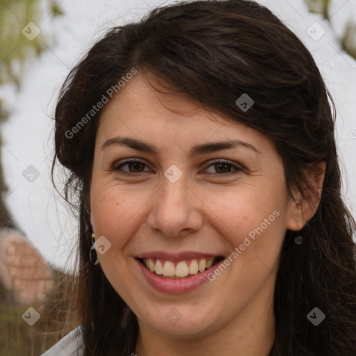 Joyful white adult female with long  brown hair and brown eyes