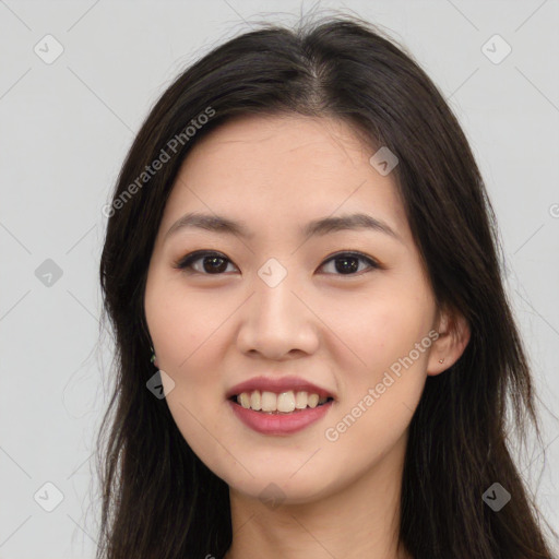 Joyful asian young-adult female with long  brown hair and brown eyes