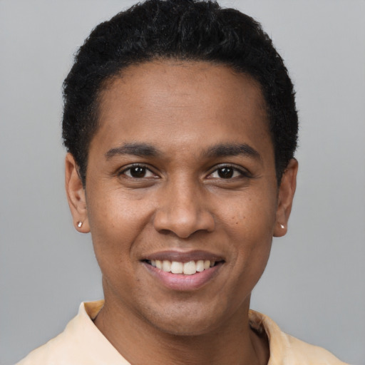 Joyful black young-adult male with short  black hair and brown eyes
