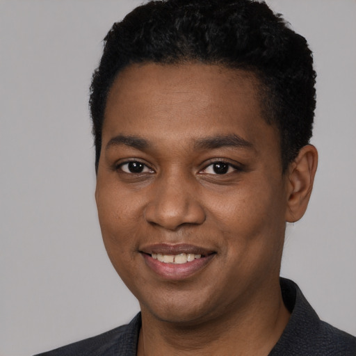 Joyful black young-adult male with short  black hair and brown eyes