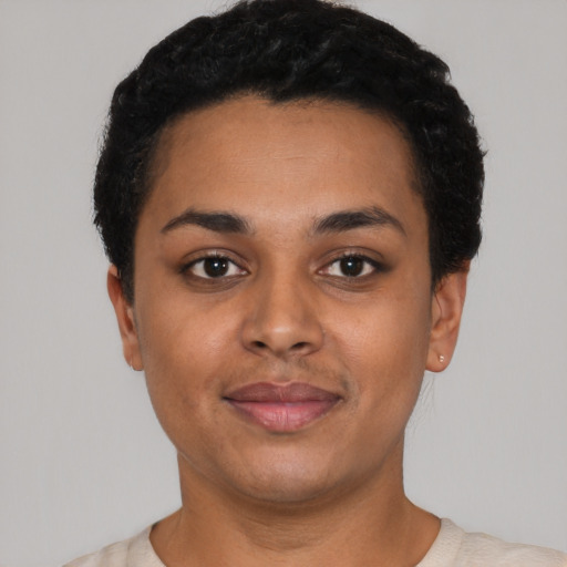 Joyful latino young-adult female with short  black hair and brown eyes