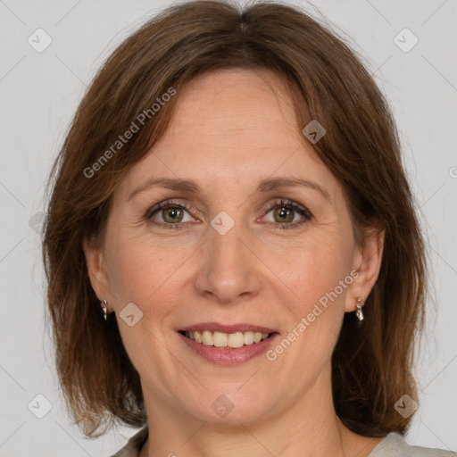 Joyful white adult female with medium  brown hair and green eyes