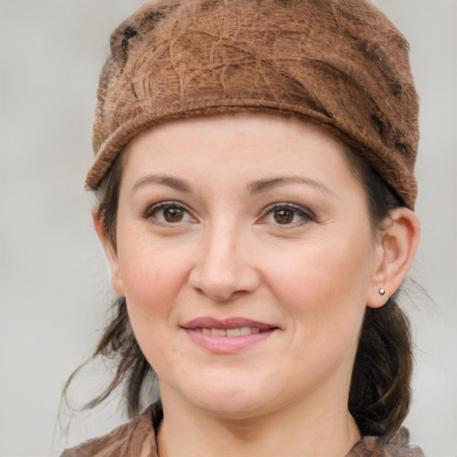 Joyful white young-adult female with medium  brown hair and grey eyes