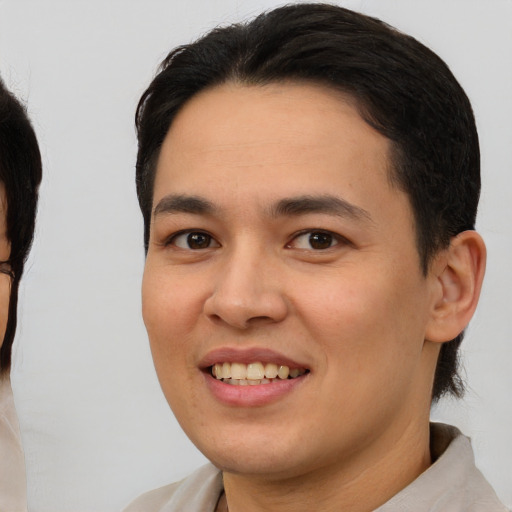 Joyful latino young-adult male with medium  brown hair and brown eyes