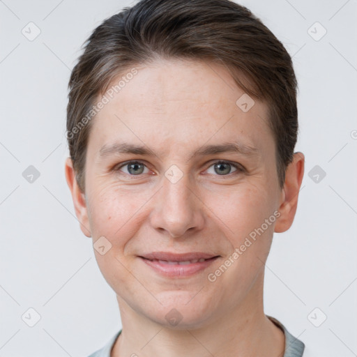 Joyful white young-adult female with short  brown hair and grey eyes