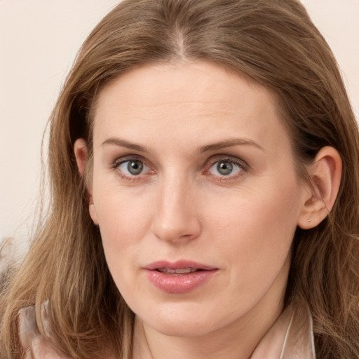 Joyful white young-adult female with long  brown hair and grey eyes