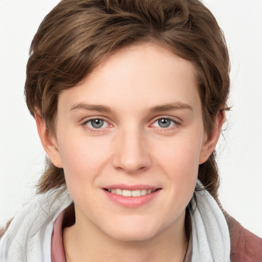 Joyful white young-adult female with medium  brown hair and blue eyes