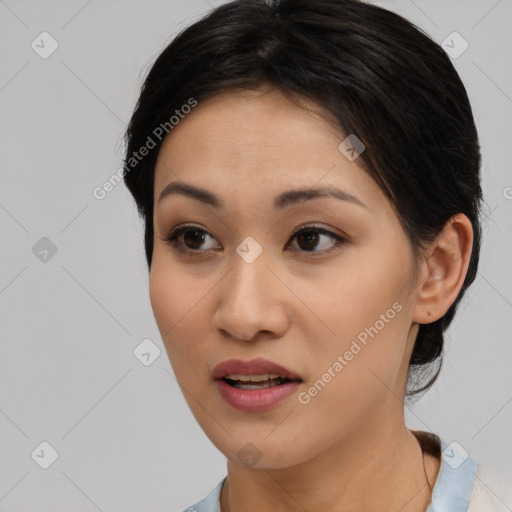 Joyful asian young-adult female with medium  black hair and brown eyes