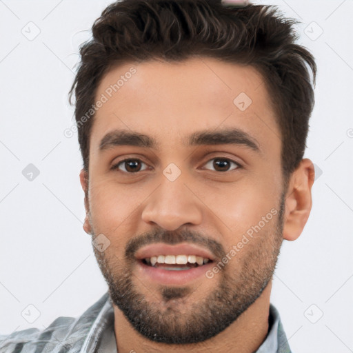 Joyful white young-adult male with short  black hair and brown eyes