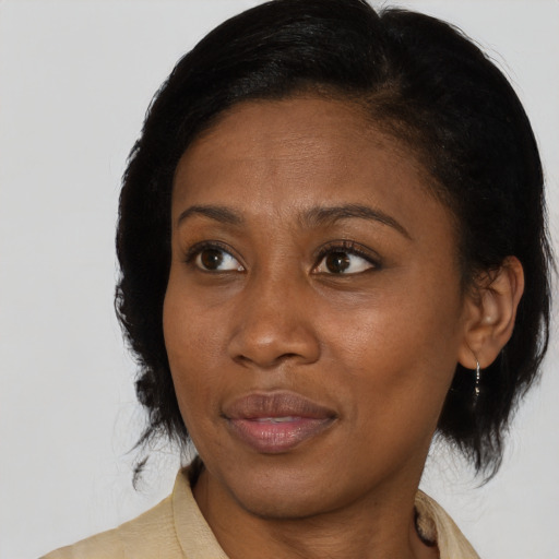 Joyful black young-adult female with medium  black hair and brown eyes