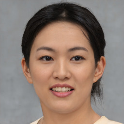 Joyful asian young-adult female with medium  brown hair and brown eyes